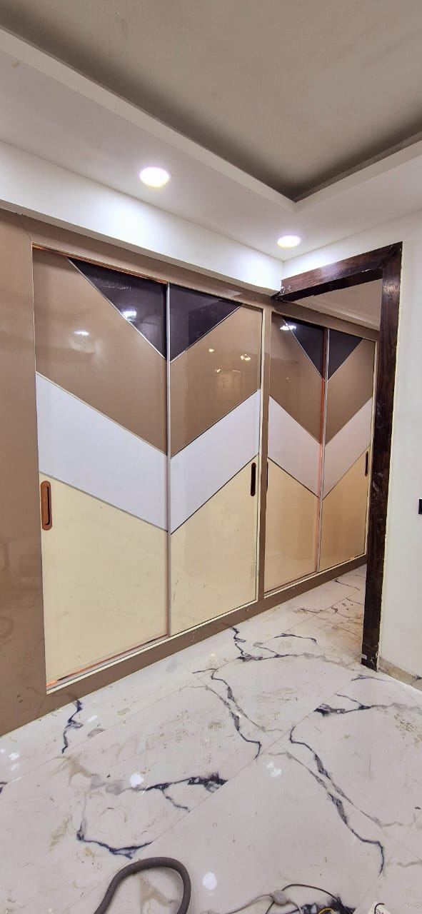 Chevron Pattern Sliding Wardrobe: Wardrobes by Supreme Kitchens, Noida
